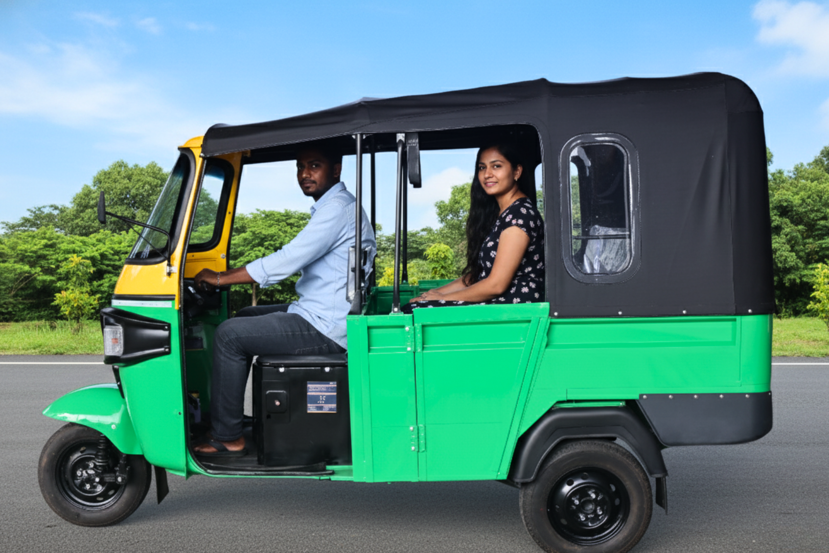 man wearing a black jacket, white shirt, blue jeans, and brown boots, playing a white electric guitar while sitting on an amp